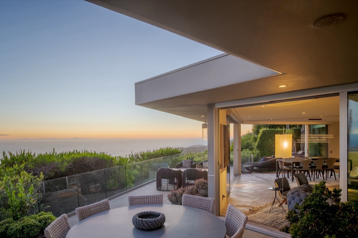 Covered terrace and open living space at dusk